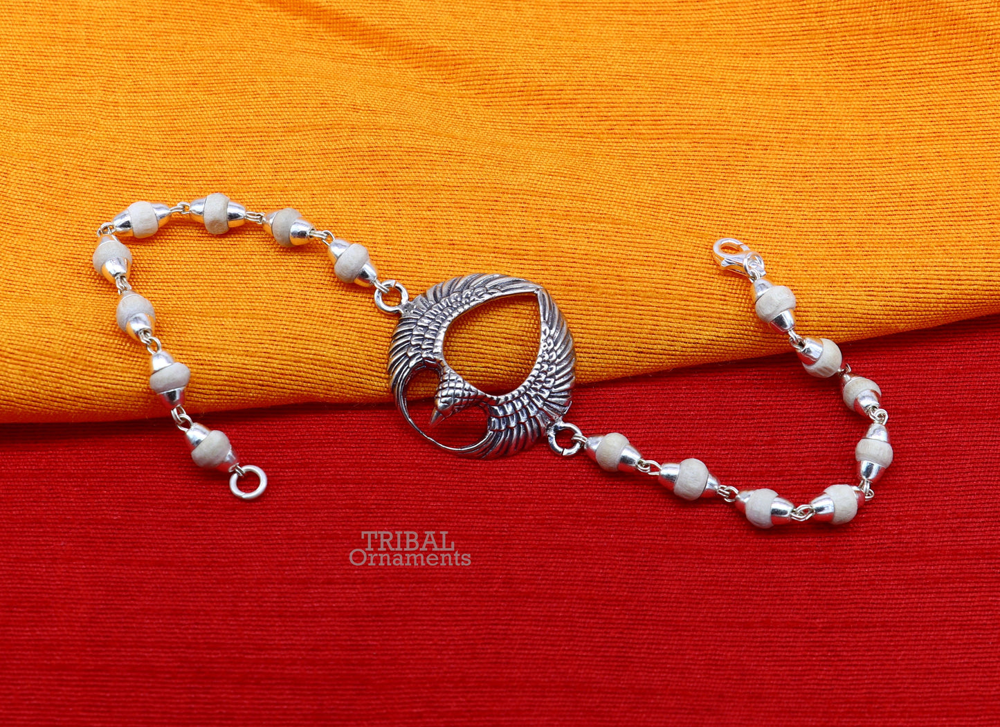 925 sterling silver Lord Garuda design Tulsi beaded bracelet rakhi by TRIBAL ORNAMENTS featuring black basil beads and intricate silver details.