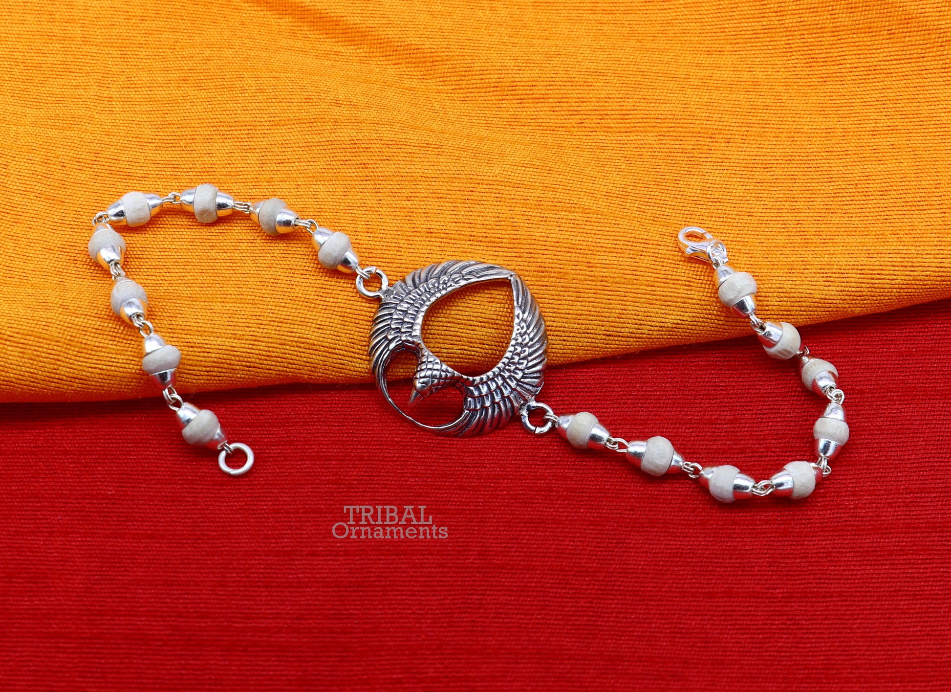 925 sterling silver Lord Garuda design Tulsi beaded bracelet rakhi by TRIBAL ORNAMENTS featuring black basil beads and intricate silver details.