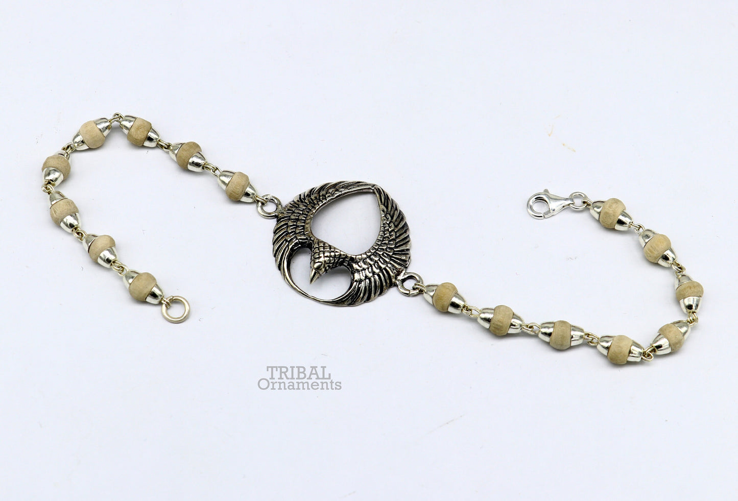 925 sterling silver Lord Garuda tulsi beaded bracelet rakhi by TRIBAL ORNAMENTS, featuring intricate Garuda design and basil beads.