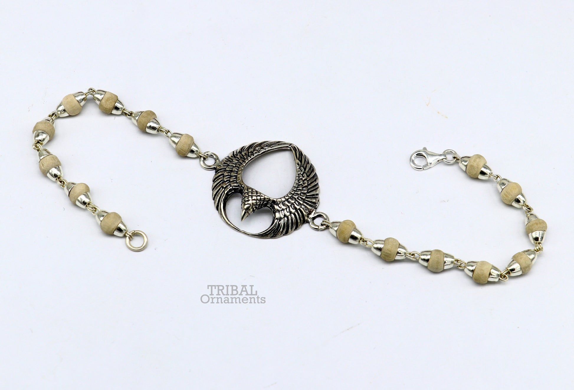 925 sterling silver Lord Garuda tulsi beaded bracelet rakhi by TRIBAL ORNAMENTS, featuring intricate Garuda design and basil beads.