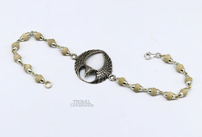 925 sterling silver Lord Garuda tulsi beaded bracelet rakhi by TRIBAL ORNAMENTS, featuring intricate Garuda design and basil beads.