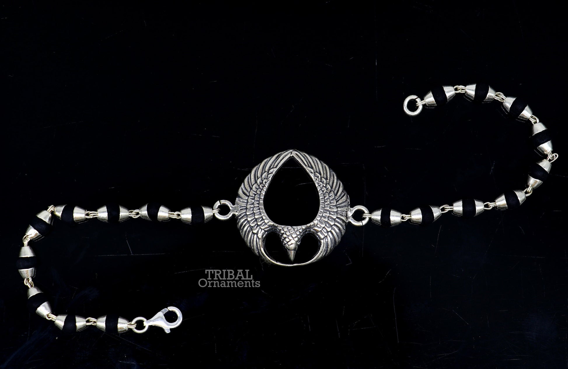 925 sterling silver Lord Garuda design Tulsi beaded bracelet rakhi by TRIBAL ORNAMENTS with black basil beads and intricate silver details.