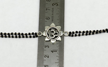 Sterling silver OM design black beaded bracelet by TRIBAL ORNAMENTS, adjustable 6 to 8.5 inches, personalized for gifting.