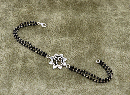 Sterling silver OM design black beaded bracelet with customizable elements, crafted by TRIBAL ORNAMENTS, 6 to 8.5 inches.