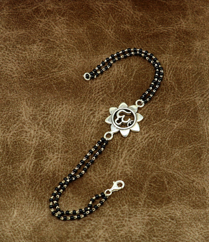 Sterling silver OM beaded bracelet with black beads, customizable 6 to 8.5 inches, tribal ornaments design, perfect for rakhi gifting.