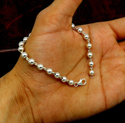 Sterling silver handmade unisex beaded bracelet with 5.5mm round beads, 8-inch length, stylish and customizable jewelry.