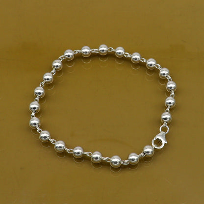 Sterling silver handmade beaded bracelet with 5.5mm round beads, 8-inch unisex style, crafted by TRIBAL ORNAMENTS.