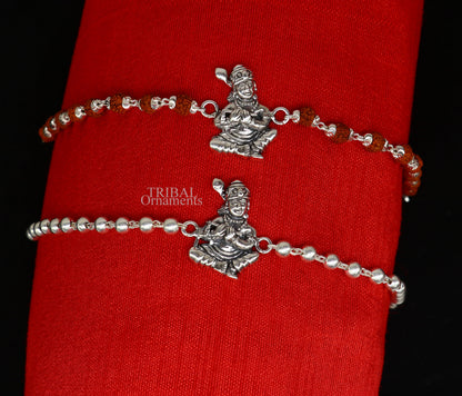 Sterling silver Lord Krishna design Rudraksha beads bracelet rakhi with intricate details and personalized touch by TRIBAL ORNAMENTS.