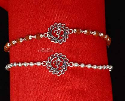 Sterling silver OM Rudraksha bracelet rakhi with silver beads, featuring divine Aum symbol from TRIBAL ORNAMENTS.