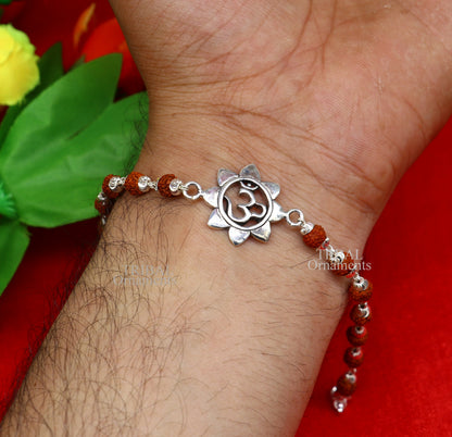 925 sterling silver flower OM design Rudraksha beaded bracelet rakhi with handmade Tulsi beads and intricate tribal ornament details.