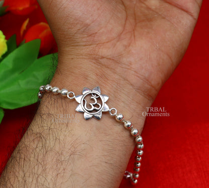 Handmade 925 sterling silver flower OM design Rudraksha beaded bracelet with Tulsi beads, crafted by TRIBAL ORNAMENTS.