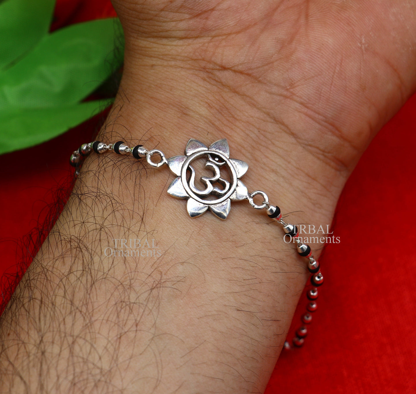 Sterling silver flower OM design Rudraksha beaded bracelet with handcrafted Aum symbols, traditional Rakhi by TRIBAL ORNAMENTS.
