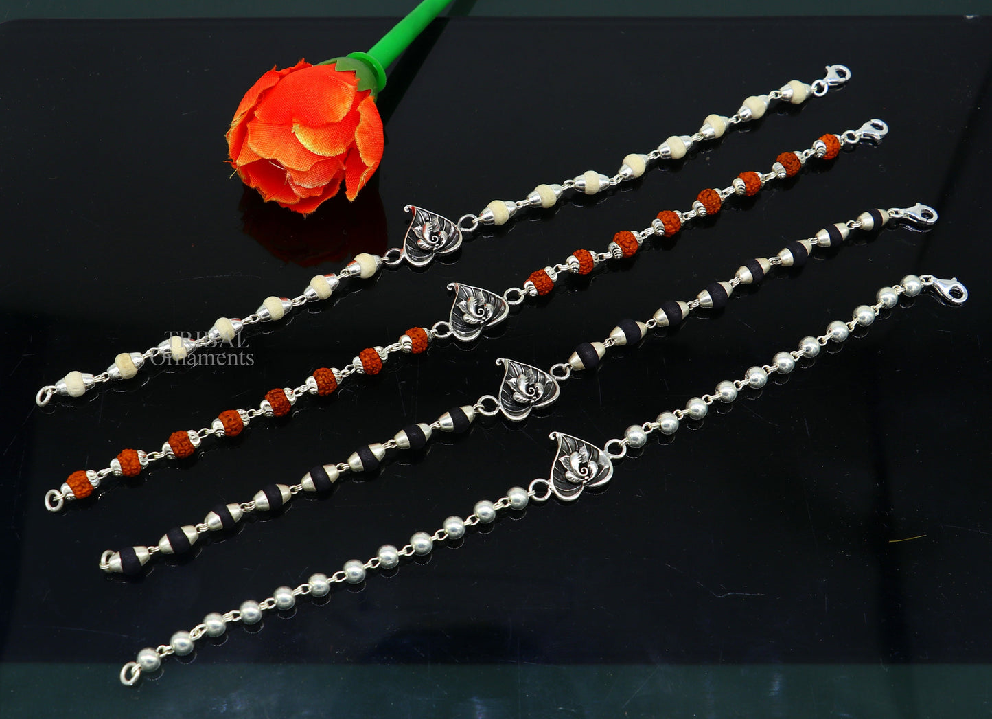 Sterling silver Lord Ganesha on Paan design Rudraksha and Tulsi bead bracelet rakhi with intricate handmade details.