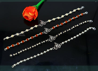 Sterling silver Lord Ganesha on Paan design Rudraksha and Tulsi bead bracelet rakhi with intricate handmade details.