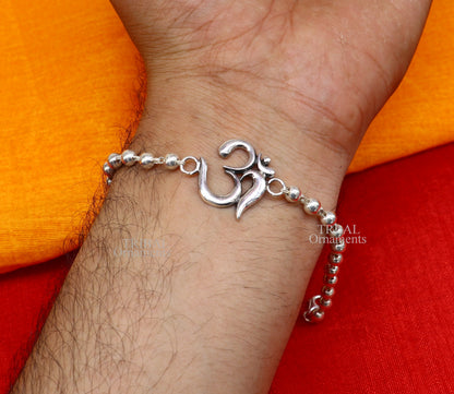 Handmade 925 sterling silver Rudraksha bead bracelet with OM design, featuring Tulsi beads, crafted by TRIBAL ORNAMENTS.