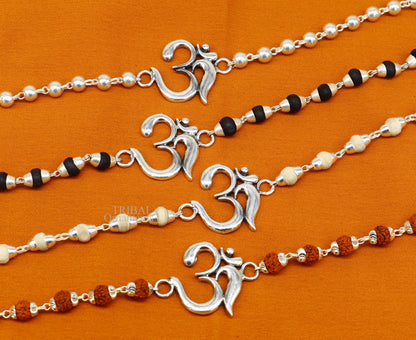 Sterling silver OM design Rudraksha and Tulsi beaded bracelet rakhi with handmade mantra accents, crafted by Tribal Ornaments.
