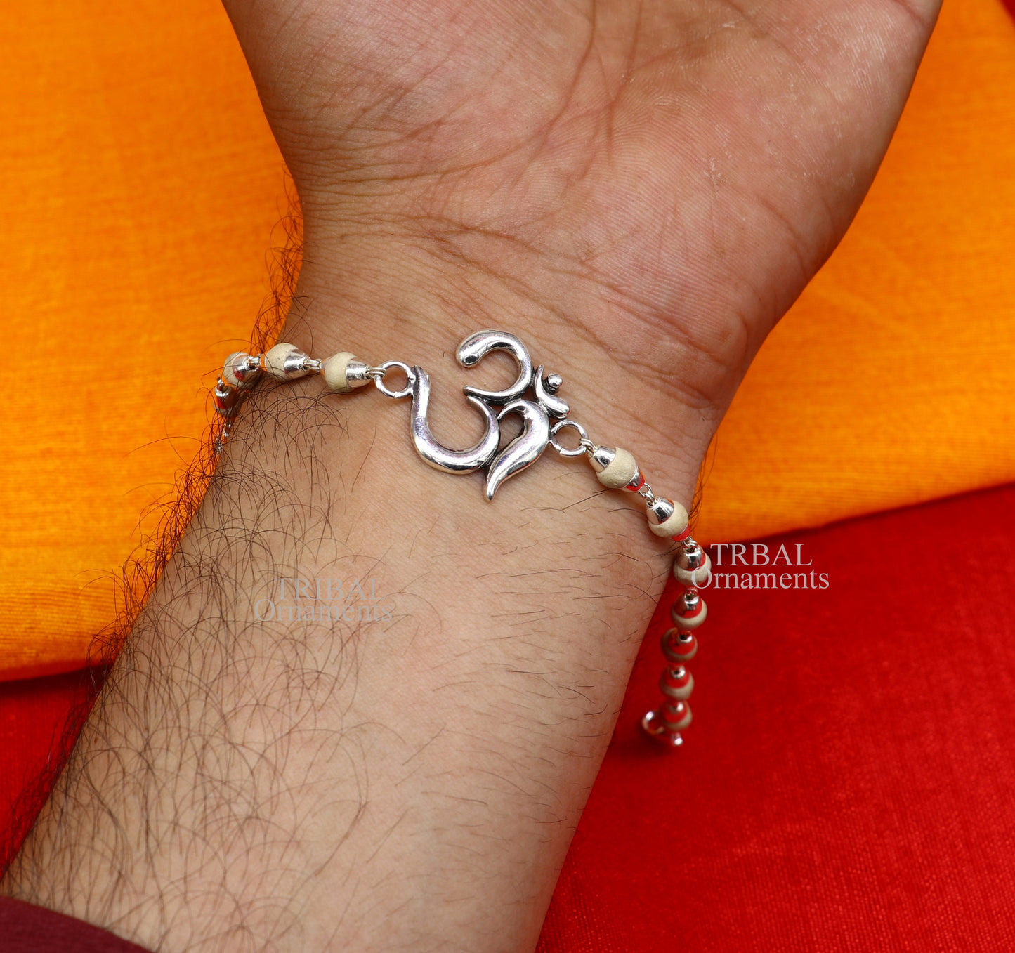 Sterling silver OM Rudraksha beaded bracelet rakhi with handmade mantra design by Tribal Ornaments, featuring Rudraksha and Tulsi beads.