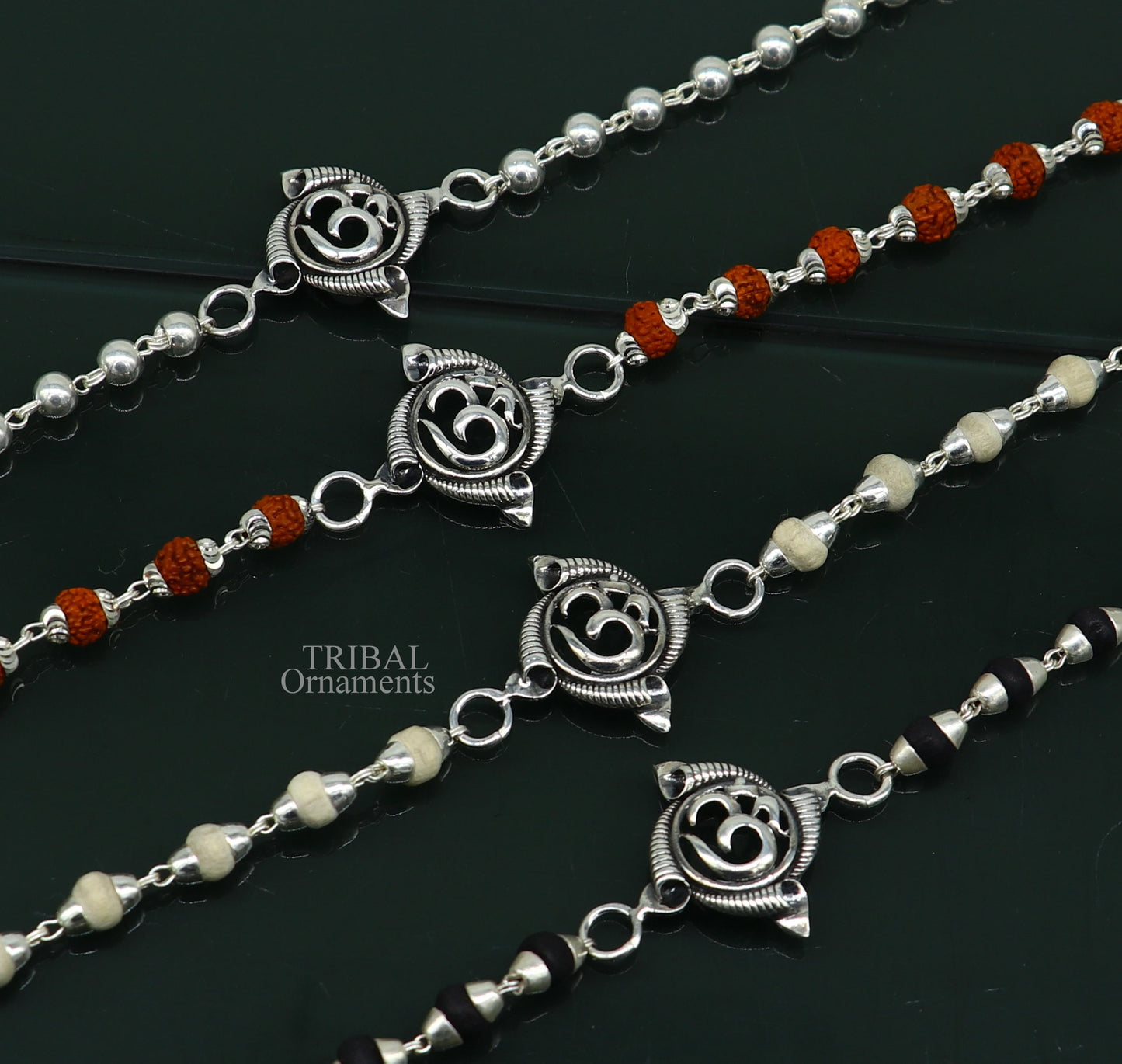 Sterling silver OM design Rudraksha and Tulsi beads bracelet by Tribal Ornaments, handmade with intricate craftsmanship.