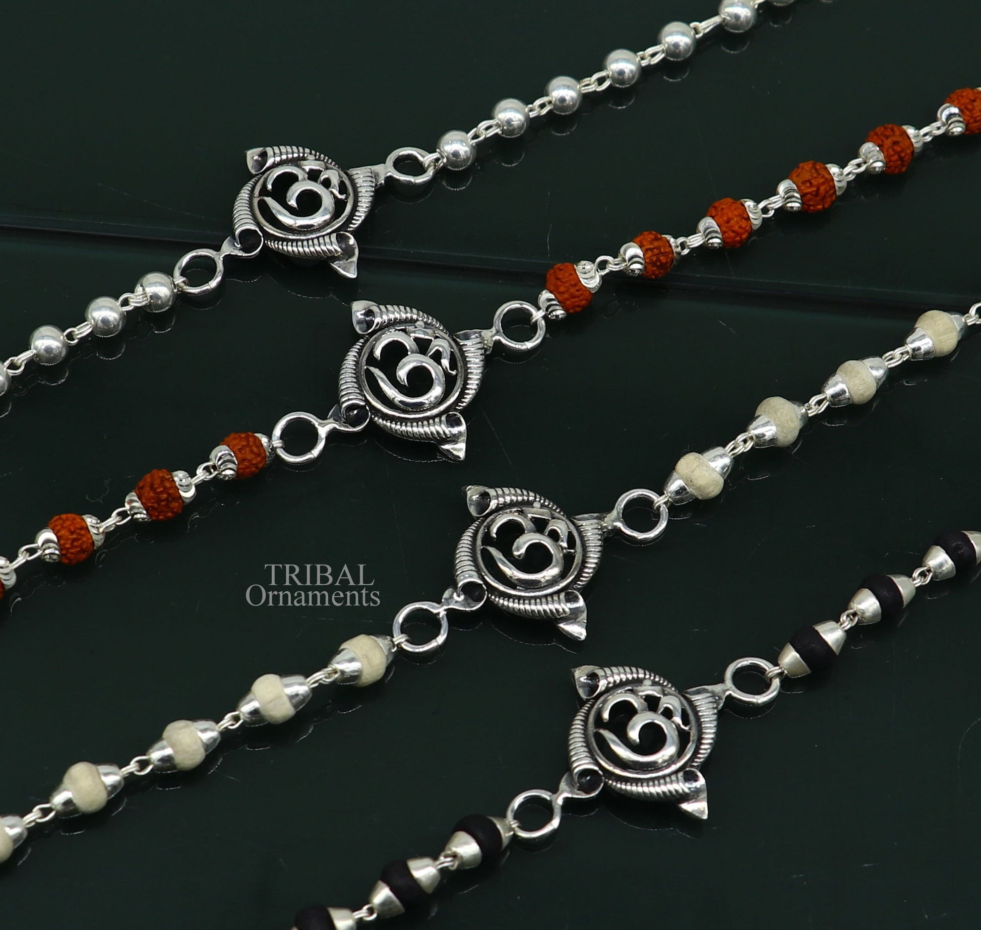 Sterling silver OM design Rudraksha and Tulsi beads bracelet by Tribal Ornaments, handmade with intricate craftsmanship.