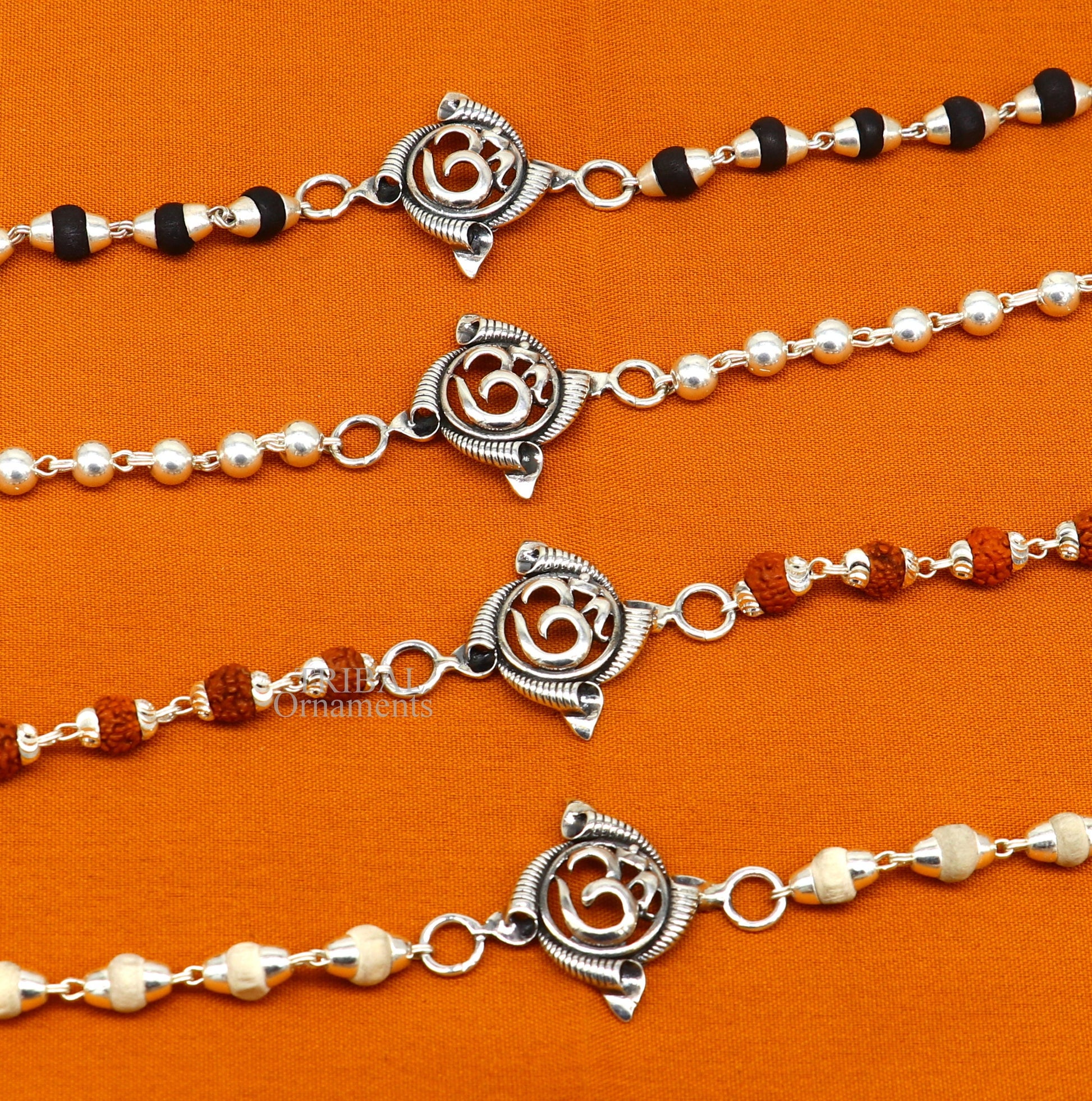 Sterling silver OM Rudraksha and Tulsi beads bracelet by TRIBAL ORNAMENTS, featuring handmade, stylish divine design.
