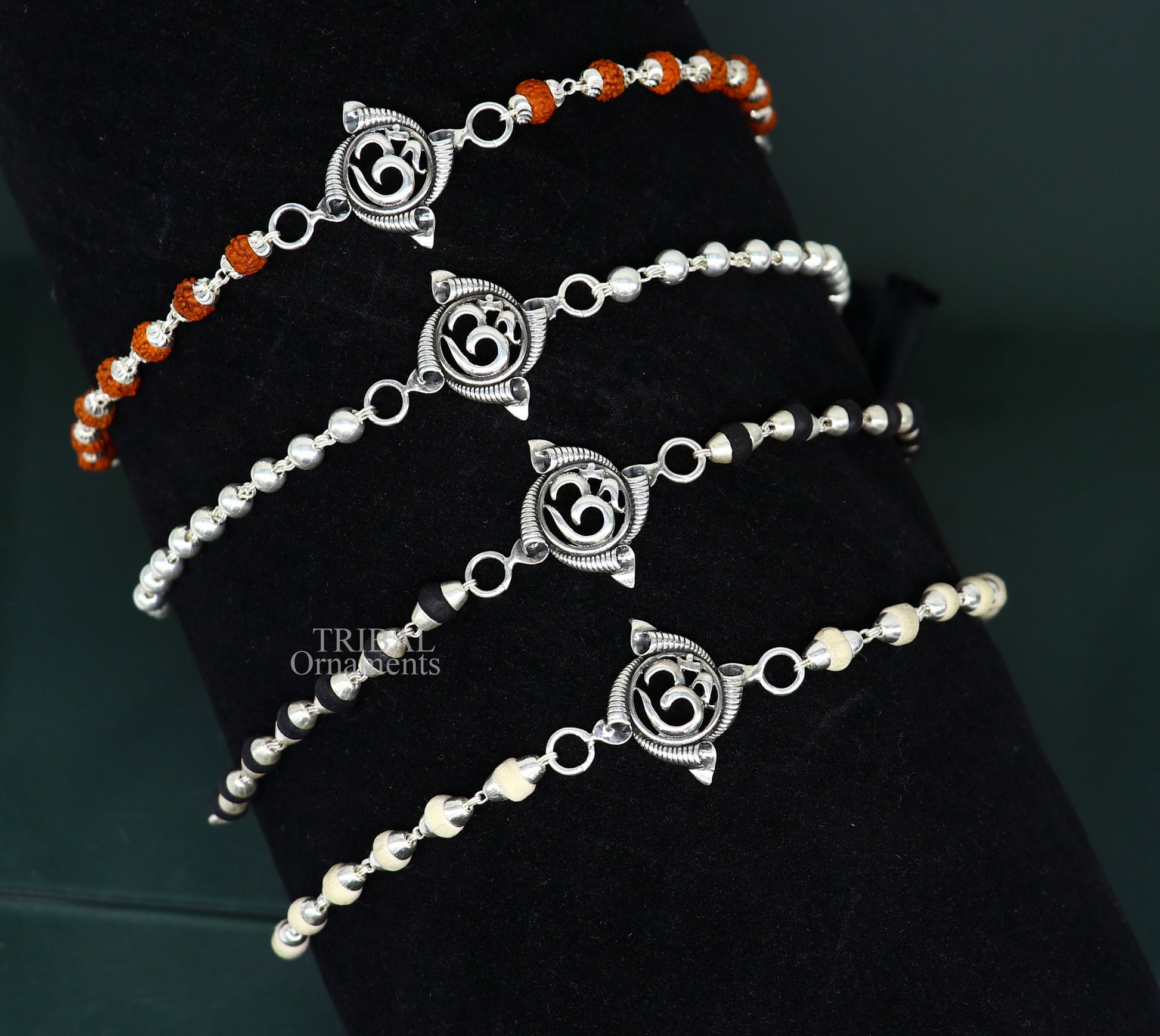 Sterling silver OM design Rudraksha and Tulsi beads bracelet, handmade tribal-style rakhi with intricate details and spiritual symbols.