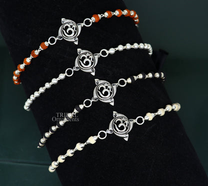 Sterling silver OM design Rudraksha and Tulsi beads bracelet, handmade tribal-style rakhi with intricate details and spiritual symbols.