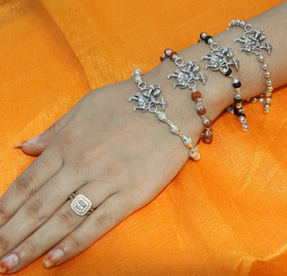 Sterling silver Flying Hanuman Rudraksha and Tulsi bead bracelet rakhi with intricate design and beaded accents, crafted by TRIBAL ORNAMENTS.