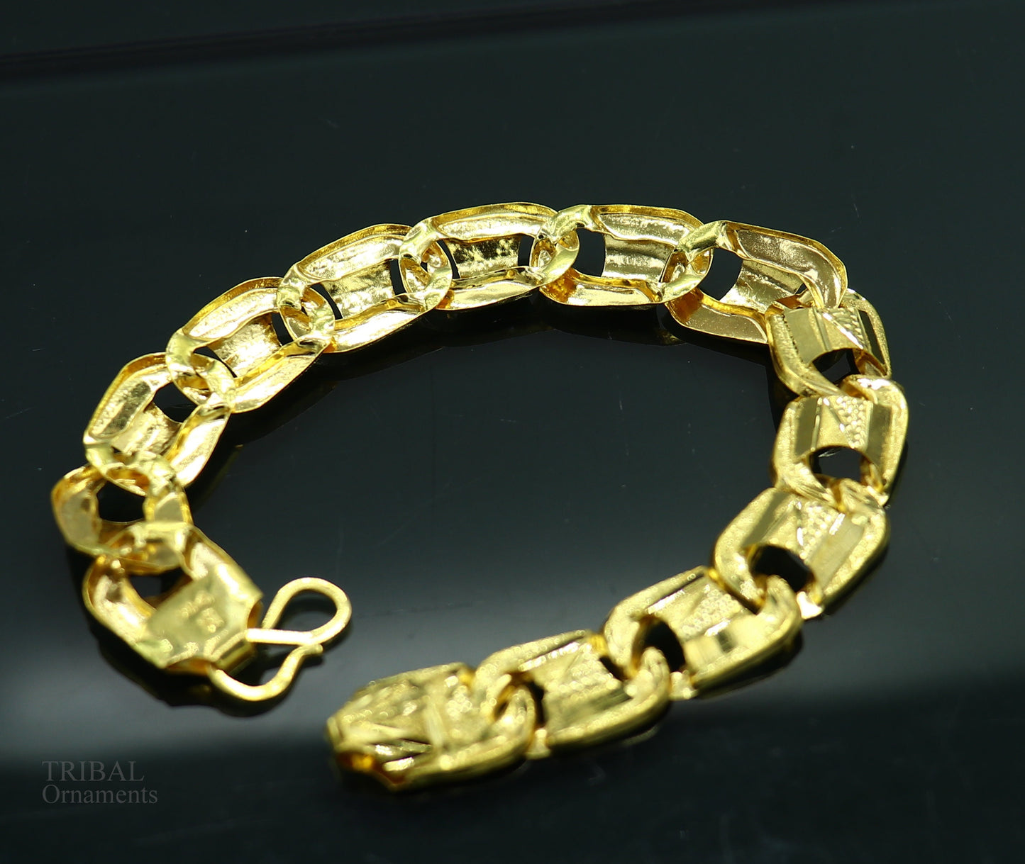 22KT yellow gold handcrafted diamond-cut designer flexible bracelet by TRIBAL ORNAMENTS, stylish unisex jewelry with intricate design.
