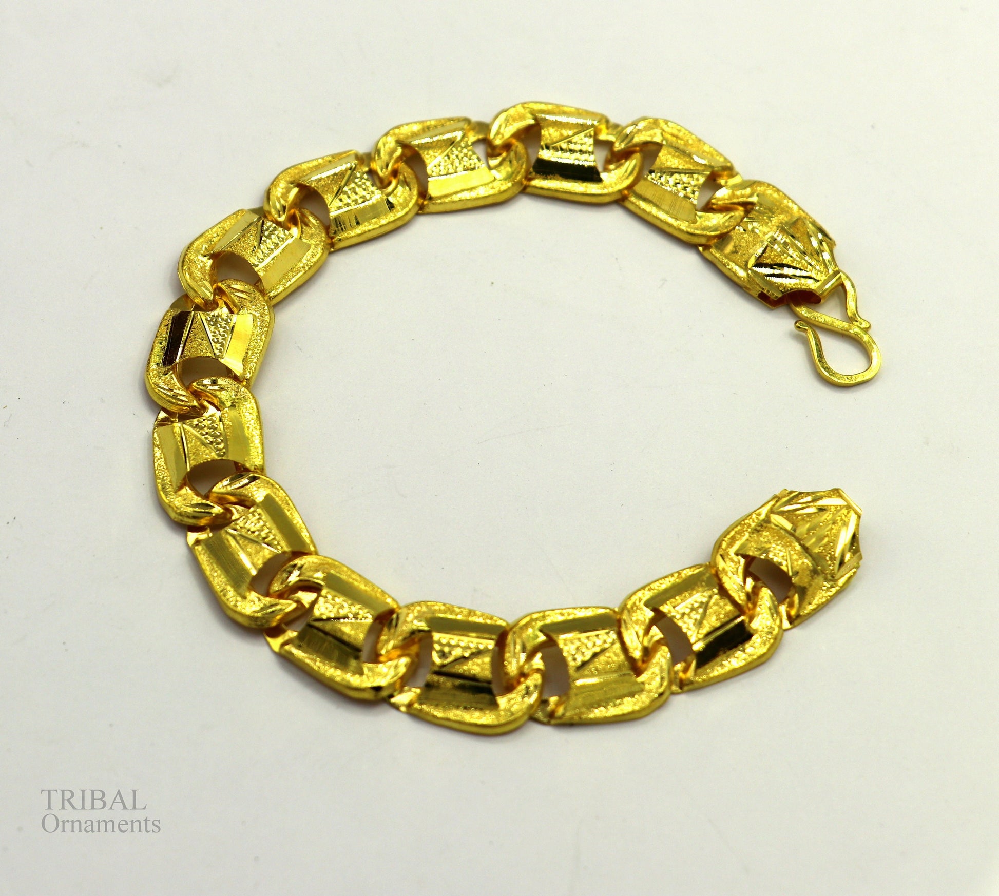 22KT yellow gold handcrafted diamond-cut designer flexible bracelet by Tribal Ornaments, stylish unisex jewelry with intricate design.