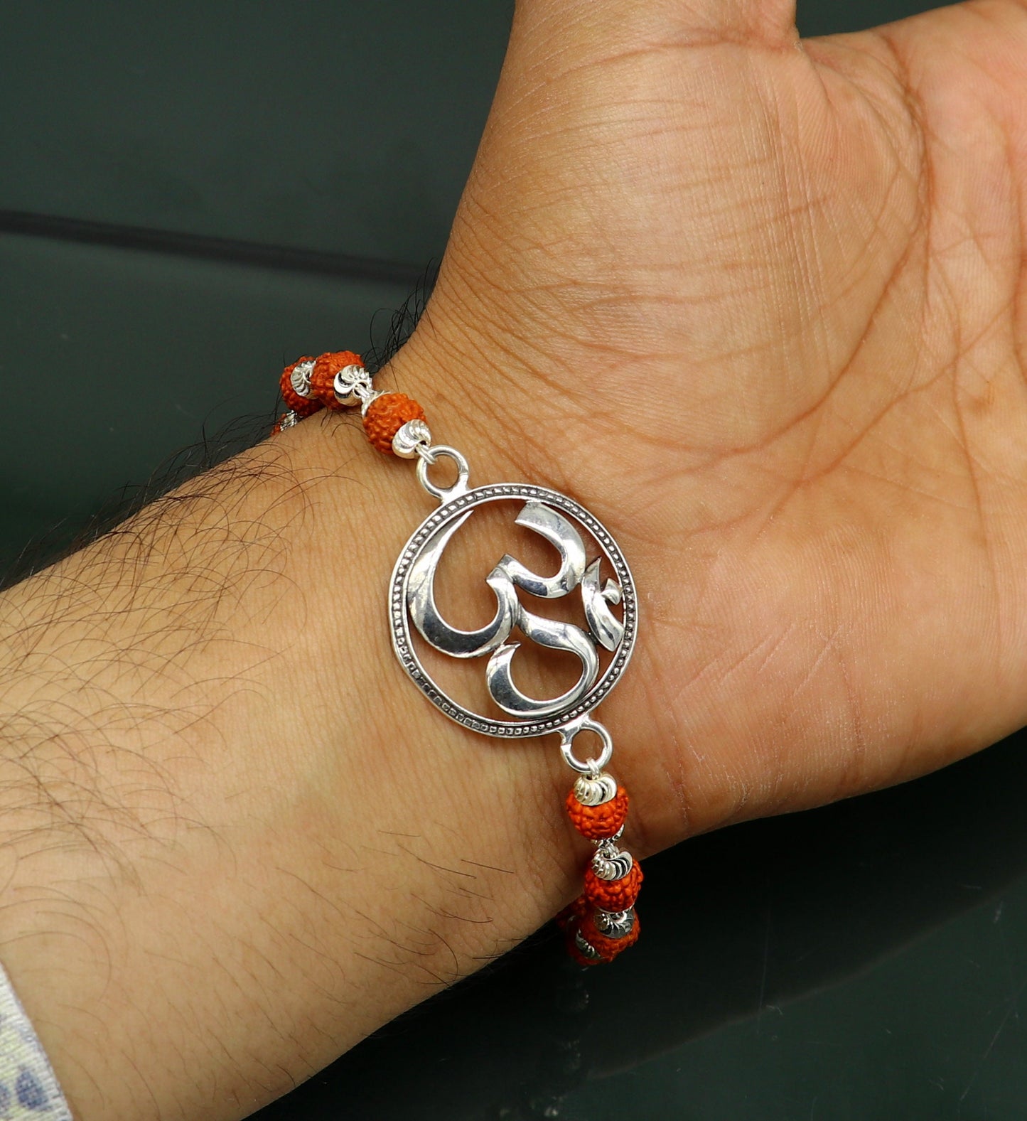 925 Sterling silver customized OM Rudraksha bead bracelet with Aum design from TRIBAL ORNAMENTS, featuring intricate bead details.