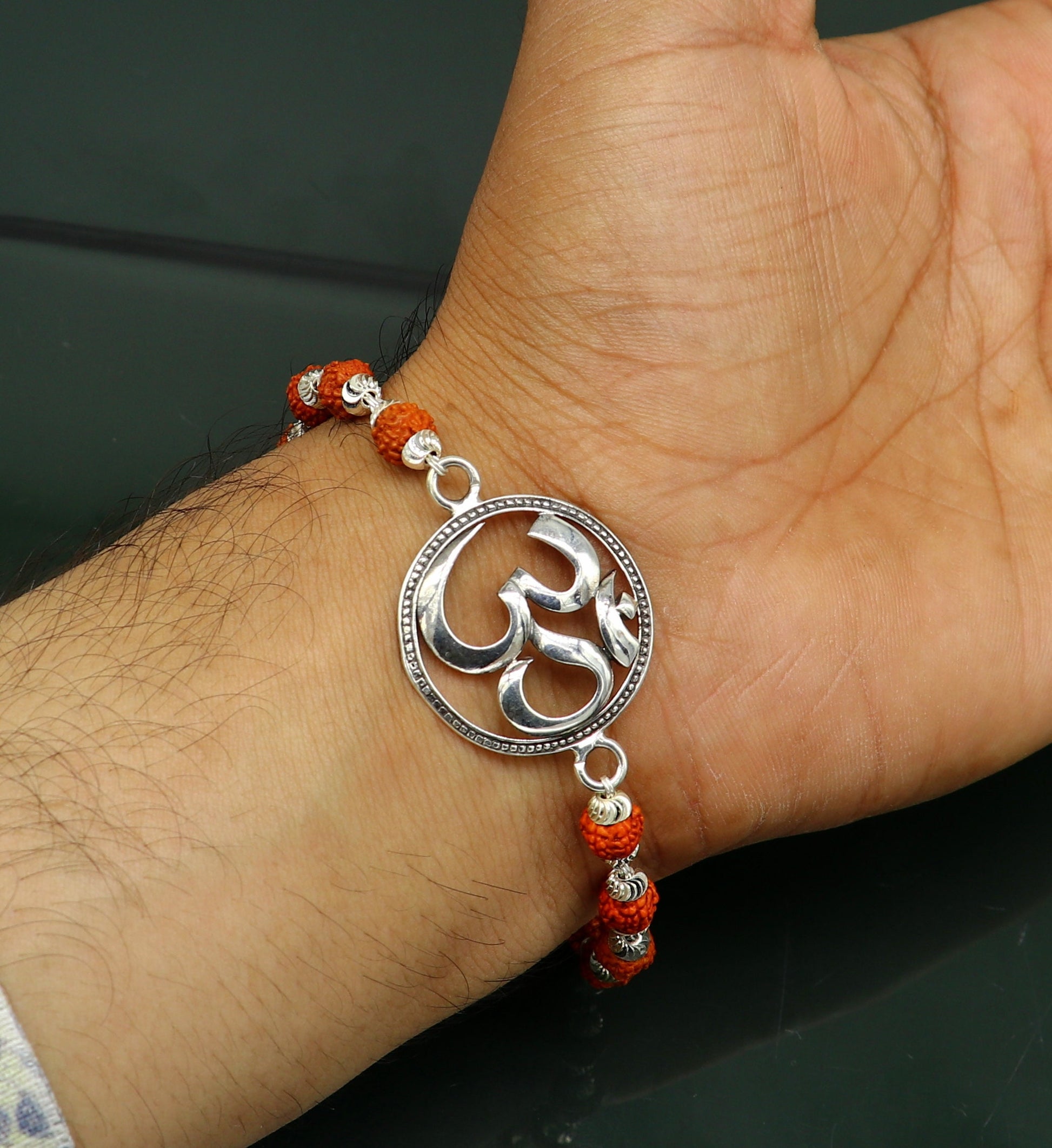 925 Sterling silver customized OM Rudraksha bead bracelet with Aum design from TRIBAL ORNAMENTS, featuring intricate bead details.
