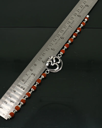 Sterling silver OM Rudraksha bead bracelet with customizable design, featuring Aum symbols, by TRIBAL ORNAMENTS.