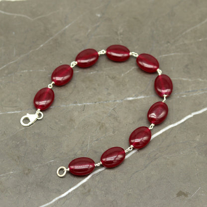 Sterling silver handmade long bracelet with oval-shaped red jade gemstone, unisex jewelry design by TRIBAL ORNAMENTS.