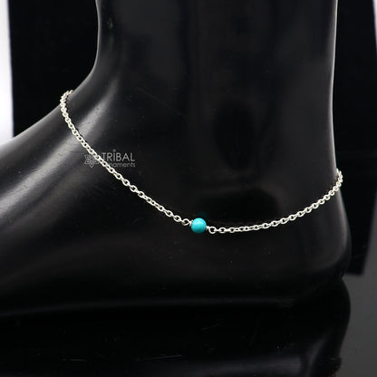 Sterling silver anklet with a single turquoise stone, lightweight and delicate 8-12 inch chain, tribal-inspired jewelry design.
