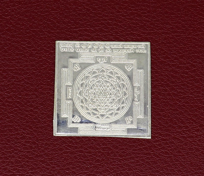 Small 3 cm solid silver Shri Laxmi Yantram for home temple puja, featuring flat design and intricate MahaLaxmi symbols.