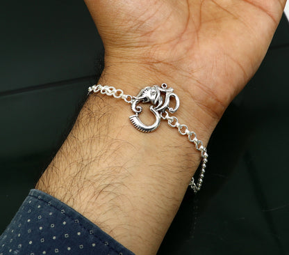 Sterling silver OM Ganesha design bracelet by TRIBAL ORNAMENTS, 7-inch handmade bracelet with Aum and Ganesha motifs.