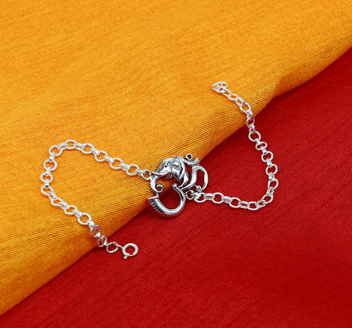 Sterling silver OM Ganesha design bracelet by TRIBAL ORNAMENTS, 7-inch handmade bracelet featuring intricate Aum and Ganesha motifs.