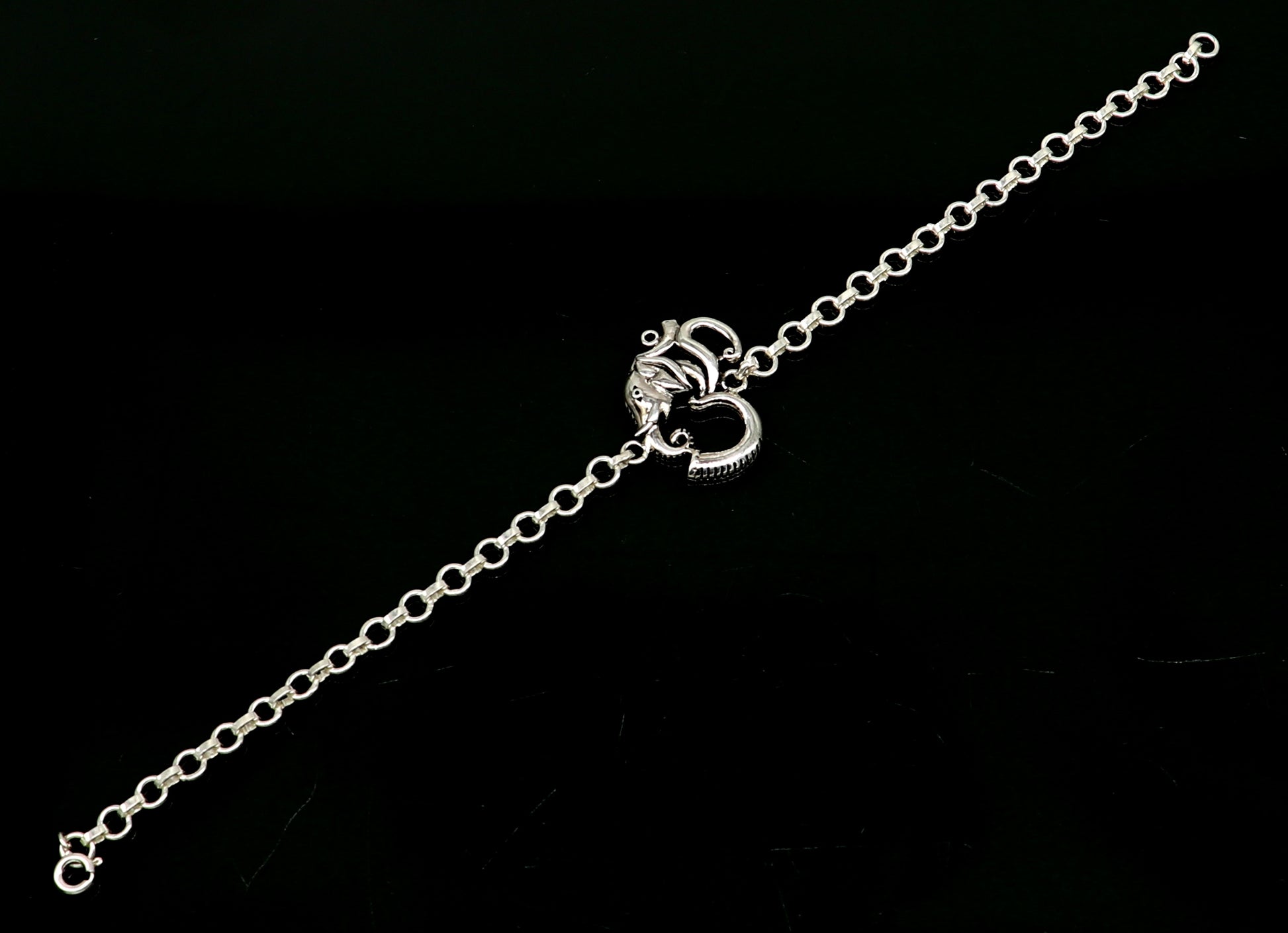 925 sterling silver OM Ganesha design bracelet by TRIBAL ORNAMENTS, handmade with intricate Aum and Ganesha motifs.