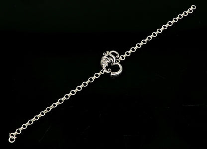 925 sterling silver OM Ganesha design bracelet by TRIBAL ORNAMENTS, handmade with intricate Aum and Ganesha motifs.