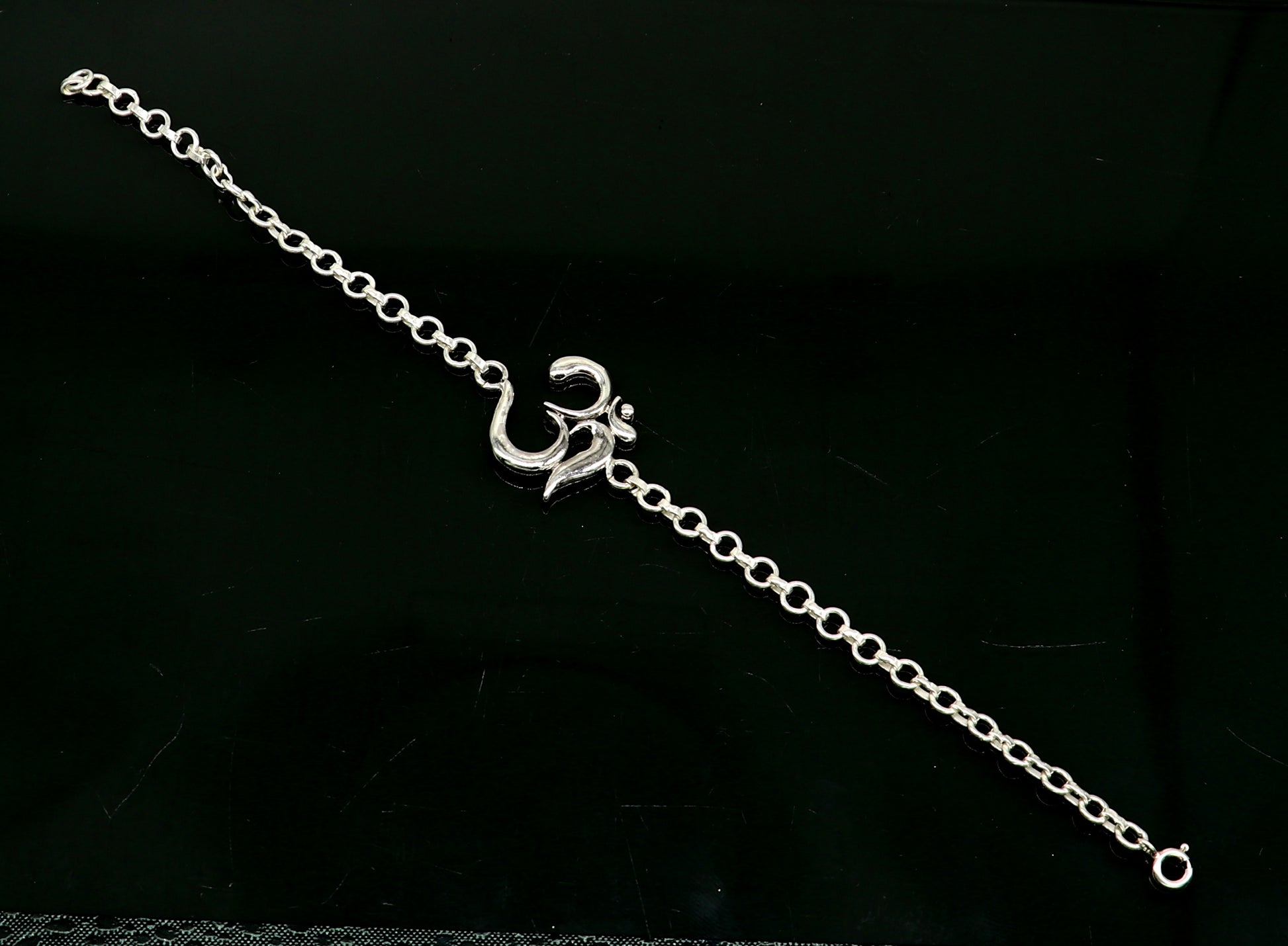Sterling silver OM mantra bracelet by TRIBAL ORNAMENTS, handmade 7-inch bracelet with intricate Aum design in all sizes.