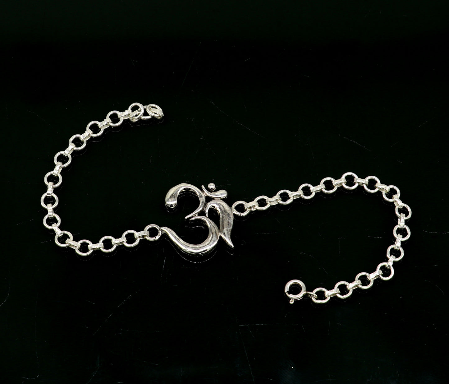 Sterling silver OM mantra bracelet by Tribal Ornaments, handmade 7-inch bracelet with intricate Aum design, available in all sizes.