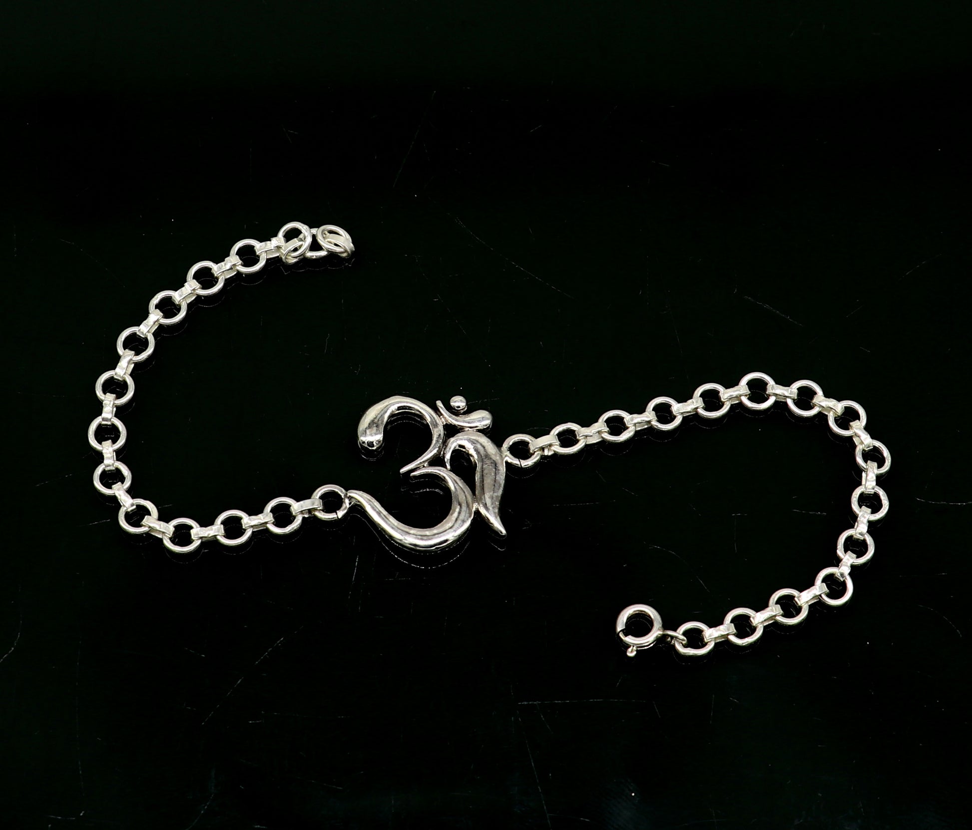 Sterling silver OM mantra bracelet by Tribal Ornaments, handmade 7-inch bracelet with intricate Aum design, available in all sizes.