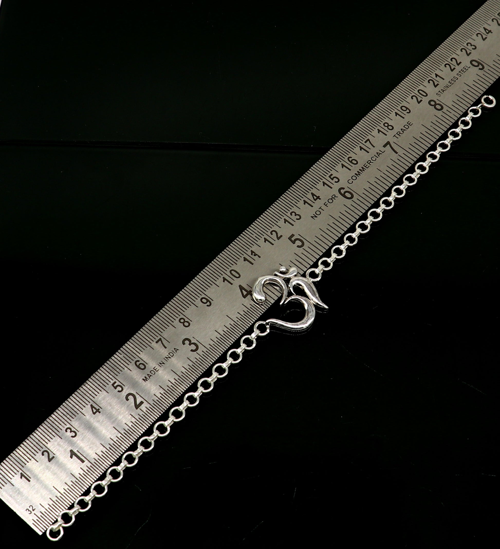Sterling silver OM mantra bracelet by TRIBAL ORNAMENTS, handmade 7-inch bracelet with intricate Aum design.