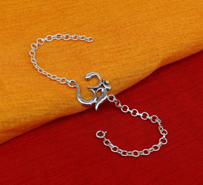 Sterling silver OM mantra bracelet by TRIBAL ORNAMENTS, handmade 7-inch design with intricate Aum Om symbols and adjustable sizes.