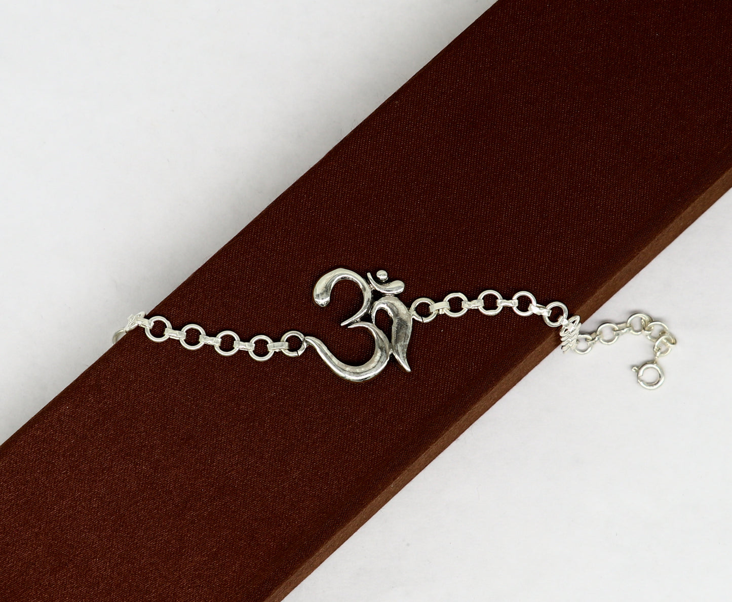 Sterling silver OM mantra bracelet by TRIBAL ORNAMENTS, handmade 7-inch design with intricate Aum OM symbols, all sizes available.