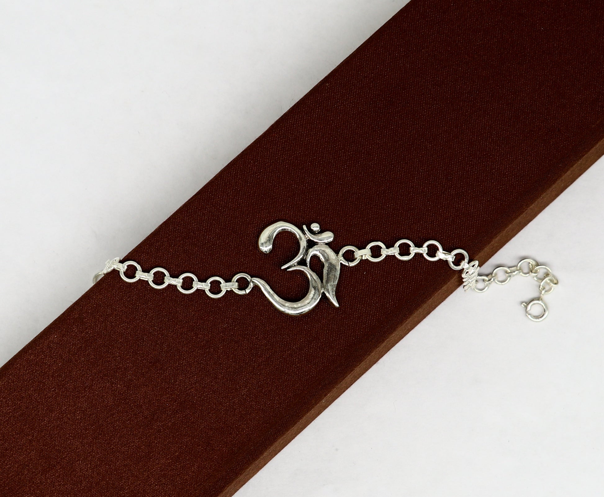 Sterling silver OM mantra bracelet by TRIBAL ORNAMENTS, handmade 7-inch design with intricate Aum OM symbols, all sizes available.
