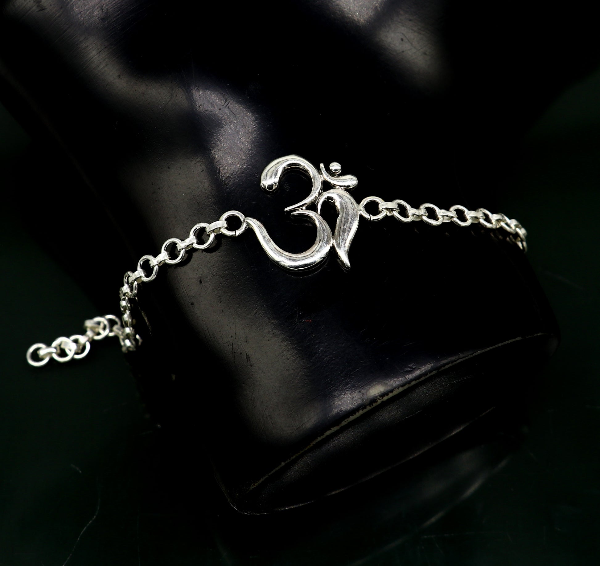 Sterling silver OM mantra bracelet by TRIBAL ORNAMENTS, handmade 7-inch bracelet with intricate OM design and adjustable sizing.
