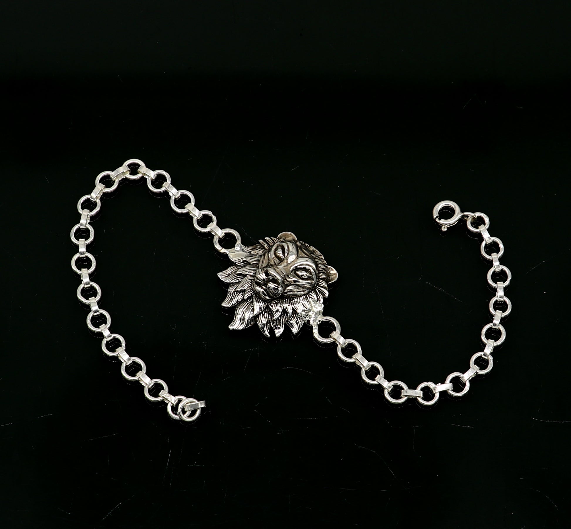 Sterling silver Narsimha lion face bracelet by TRIBAL ORNAMENTS, 7-inch handmade bracelet with intricate tribal design.