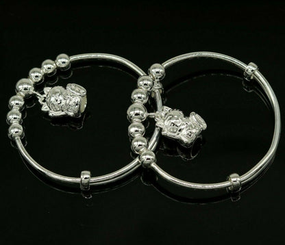 Sterling silver adjustable charm bangle bracelet by Tribal Ornaments, unisex kids and baby jewelry with intricate design.