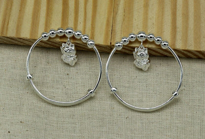 Sterling silver adjustable charm bangle bracelet for kids and babies, unisex tribal ornament design with intricate details.